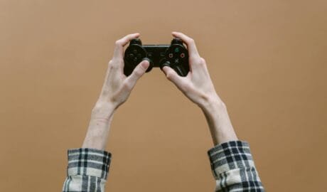 person holding a black game controller