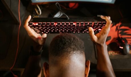 overhead shot of a man holding his mechanical keyboard