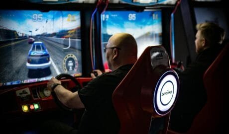 men playing daytona racing arcade games