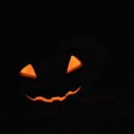glowing jack o lantern face in darkness